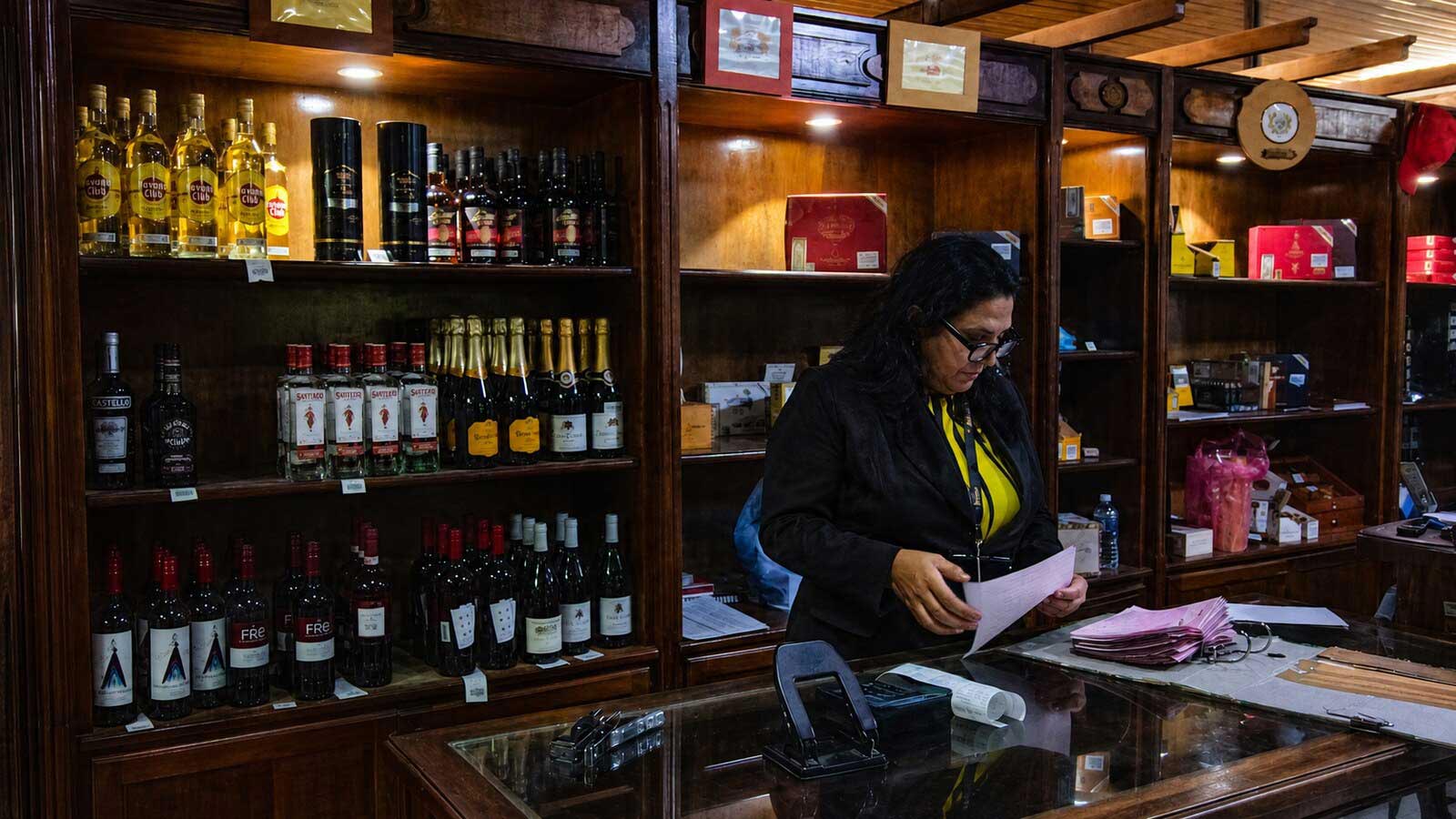 A member of the Cuban Cigar Group team assisting customers inside the Havana cigar shop